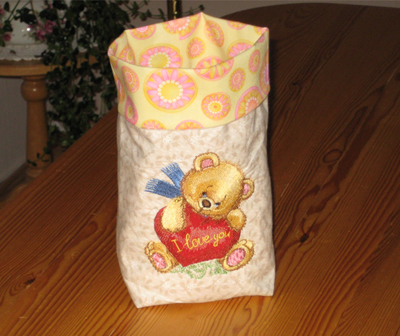 embroidered bag with old toys teddy bear